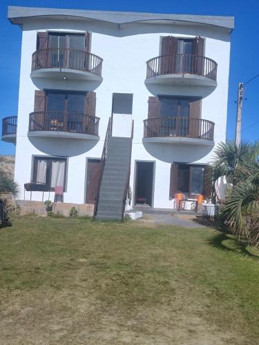 a building with two balconies on the side of it at Paraíso Chuí in Santa Vitória do Palmar