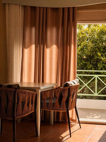 a table and two chairs in front of a window at Olivet Hotel in Vlorë
