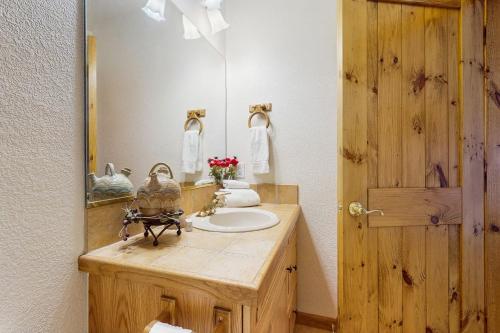 a bathroom with a wooden sink and a mirror at Lookout Ridge 63 in Dillon