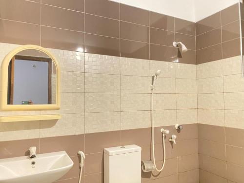 a bathroom with a shower and a toilet and a sink at Kentz villa in Arugam Bay