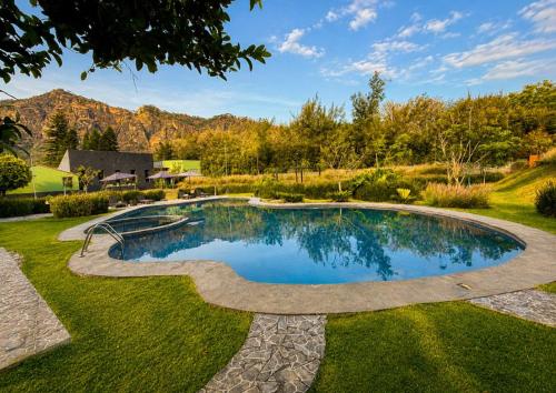a swimming pool in the middle of a yard at Orgánico Hotel Boutique TEPOZTLÁN in Tepoztlán