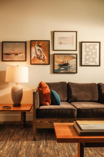 a living room with a couch and a table at Dexter Hotel in Elk Rapids