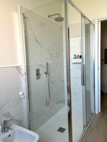 a bathroom with a shower with a toilet and a sink at La Curt by Ambroeus apartments in Inzago