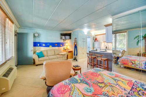 a bedroom with a bed and a living room and a kitchen at Colorful Virginia Beach Studio - Steps to Beach! in Virginia Beach