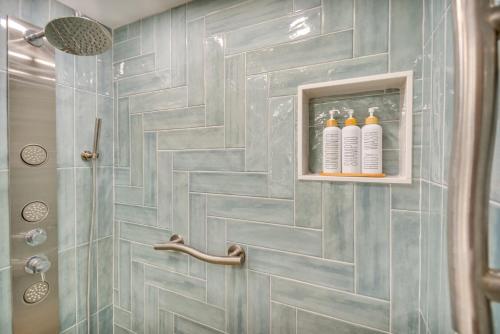 a bathroom with a shower with two bottles on a shelf at Colorful Virginia Beach Studio - Steps to Beach! in Virginia Beach