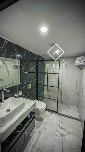 a bathroom with a sink and a toilet at BUBBLES LUXURY CAMp in Wadi Rum