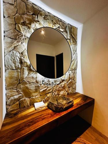 a mirror on a stone wall in a room at Hali, El Paredón in Sipacate