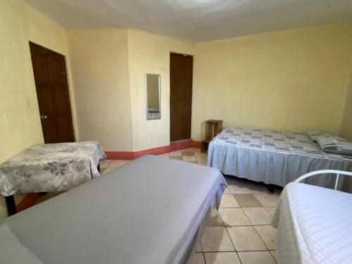 a room with two beds in a room at Casa Adelita in Huehuetenango