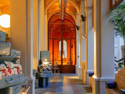 a hallway with a red door in a building at 25hours Hotel Florence Piazza San Paolino in Florence