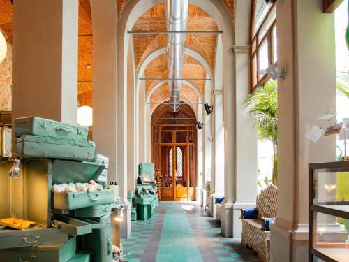 a hallway in a building with an arcade at 25hours Hotel Florence Piazza San Paolino in Florence