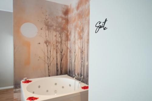 a bathroom with a bath tub with a painting on the wall at Vittorio Veneto Dimore in Bari