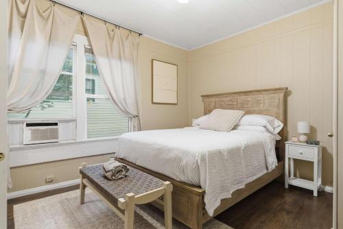 a bedroom with a large bed and a window at Cozy 1BR Cottage w Kitchen & Laundry in Lafayette