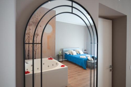 a bathroom with a large mirror and a tub at Vittorio Veneto Dimore in Bari