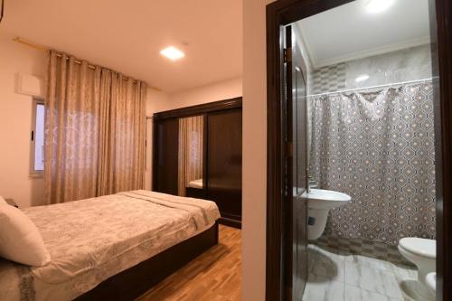 two pictures of a bedroom with a bed and a bathroom at شاليهات الشهد والحلا in Amman