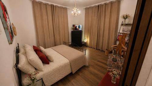 a living room with a bed and a television at B&B La Torretta dei Ricordi in Formigine