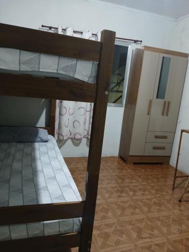 a bedroom with a bunk bed and a mirror at Pousada Familiar 31 in Campos dos Goytacazes