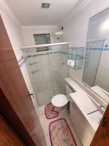 a bathroom with a toilet and a glass shower at Season Ilhéus in Ilhéus