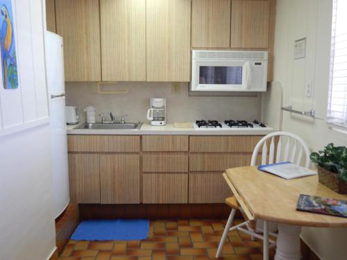 a small kitchen with a table and a microwave at Parmer's Resort in Little Torch Key