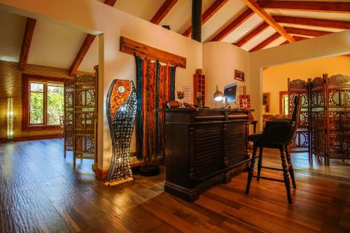 a living room with a piano and a table and chairs at Hotel Boutique Refugio El Molle in El Molle