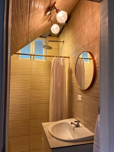 a bathroom with a sink and a mirror at Relax Home in Puyo