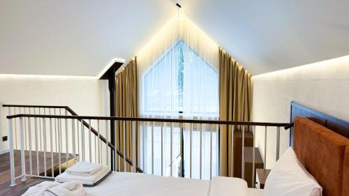 a bedroom with a bed and a large window at Нова Дача in Kozintsy