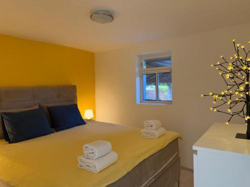 a bedroom with a bed with towels on it at Ottov Raj Na Dunavu in Krčedin