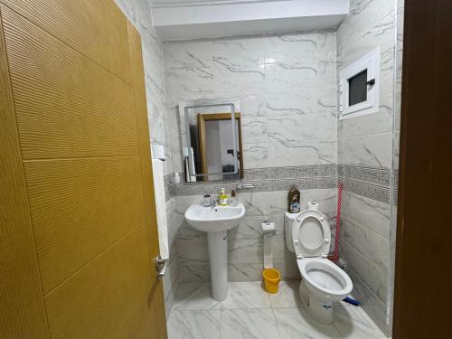 a bathroom with a toilet and a sink at Alhoceima - vue sur la mer- Green village2 in Al Hoceïma