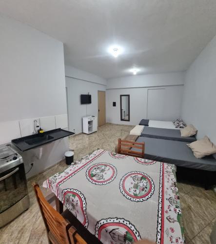 a room with two beds and a sink in it at Hotel Parque Mamed in Diadema