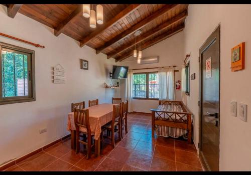 a dining room with a table and chairs at Cabañas Siddharta in Los Reartes