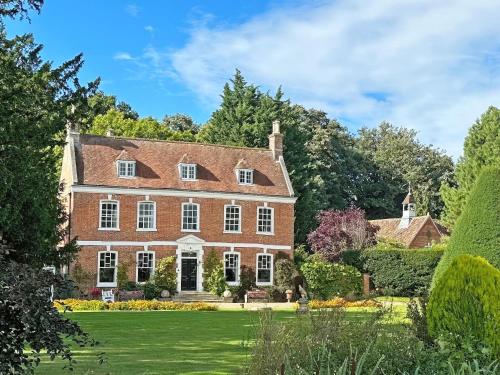 an exterior view of a large brick house with a yard at Stables - Uk51018 in Louth