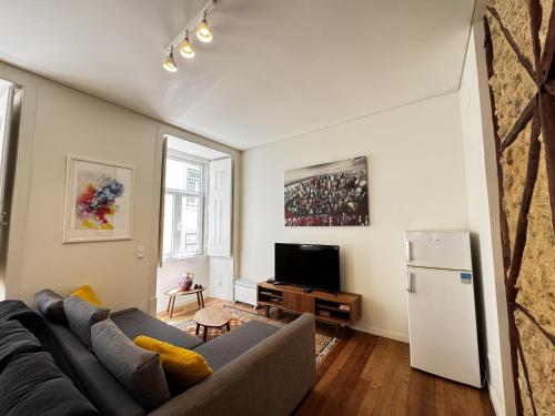 a living room with a couch and a refrigerator at Lux Old Town in Lisbon