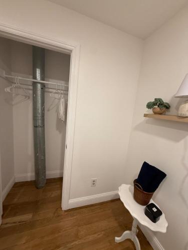 a room with a white wall with a door and a table at Homestead Bungalow in Dayton