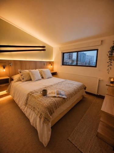 a bedroom with a large bed with a window at Loft Ski el Colorado in Santiago