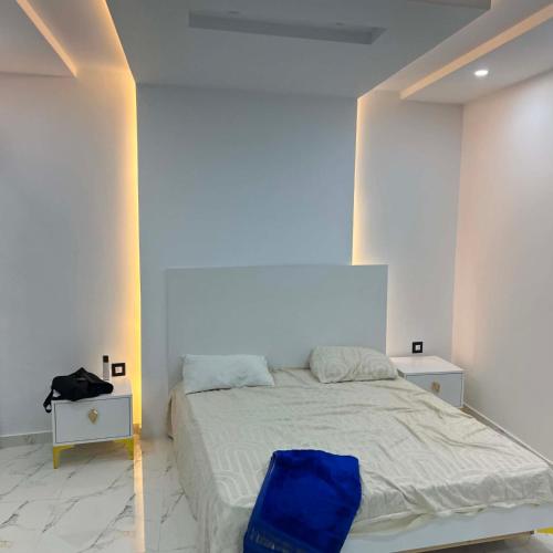 a bedroom with a bed with a blue bag on it at Villa Jenna in Kelibia