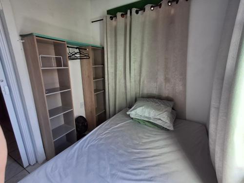 a small bed in a bedroom with a curtain at Hostel Espaço Mulher in Florianópolis