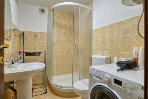 a bathroom with a sink and a washing machine at Historic Old Town Kotor in Kotor