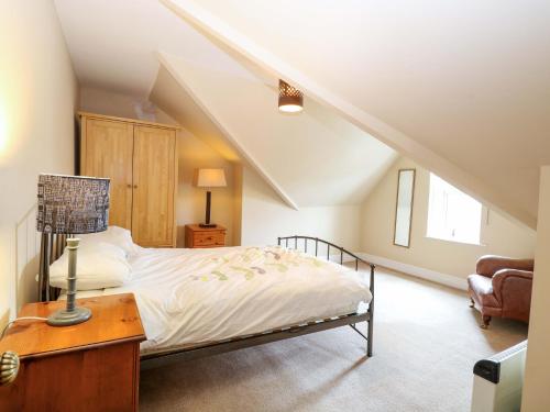 a bedroom with a bed and a lamp on a table at Tilly's Retreat in Hunstanton