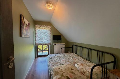 a bedroom with a bed and a window at Agroturystyka Ostoja Wilków I in Wilków