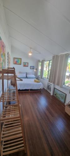 a bedroom with a bed and a wooden floor at Ocean High in Yamba