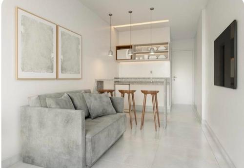 a living room with a couch and some tables and a kitchen at Apartamento no Beach Resort Salinas in Ilha de Atalaia