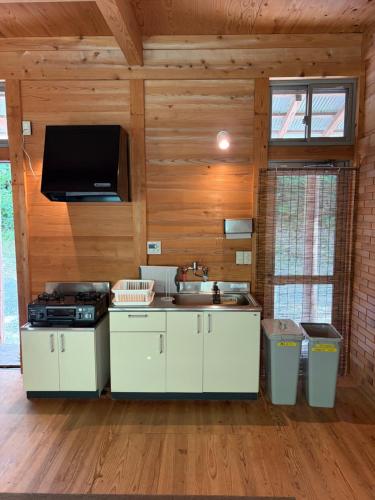 a kitchen with a sink and a tv in a room at YAMAYA BASE 1 in Ōkawamochi