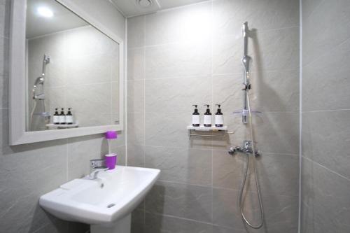 a bathroom with a shower and a sink and a shower at Hotel Don in Changwon