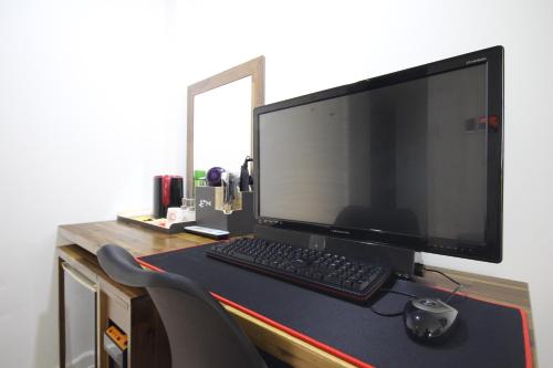 a computer monitor and a keyboard and mouse on a desk at Hotel Don in Changwon