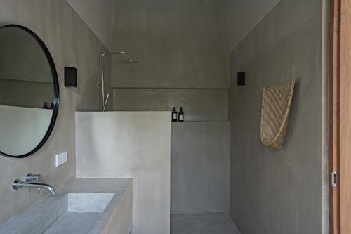a bathroom with a sink and a mirror at Tayo Villa in Ahangama