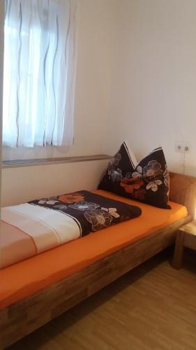 a bed with two pillows sitting on top of it at Ferienhaus Sporer in Iselsberg