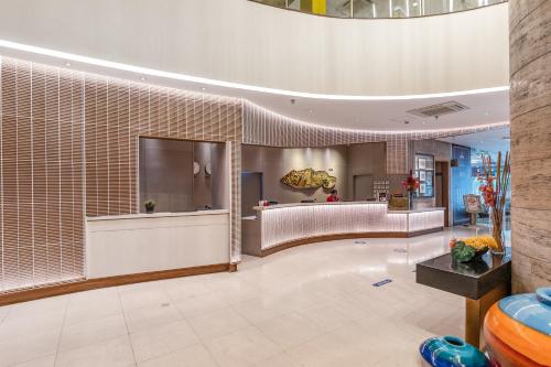 a lobby of a hotel with a large room at Crown Regency Hotel & Towers in Cebu City