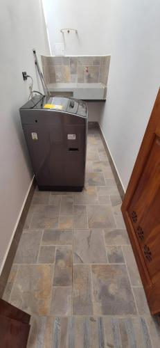 a kitchen with a counter and a tile floor at Portón del Río Jericó in Jericó