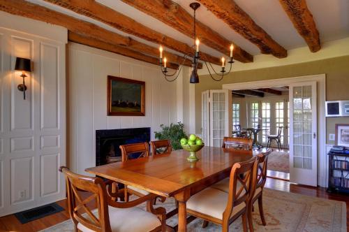 a dining room with a wooden table and chairs at The Baker House 1650 in East Hampton