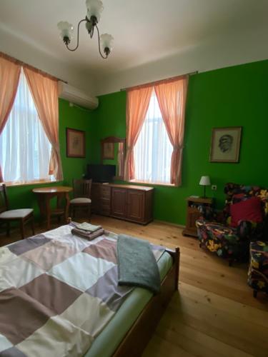 a bedroom with green walls and a bed at Art Studios Elsor in Burgas