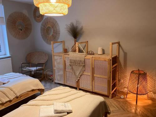 a room with two beds and a chandelier at Comfortable Jacuzzi Apartment for 8 in Stezyca in Stężyca
